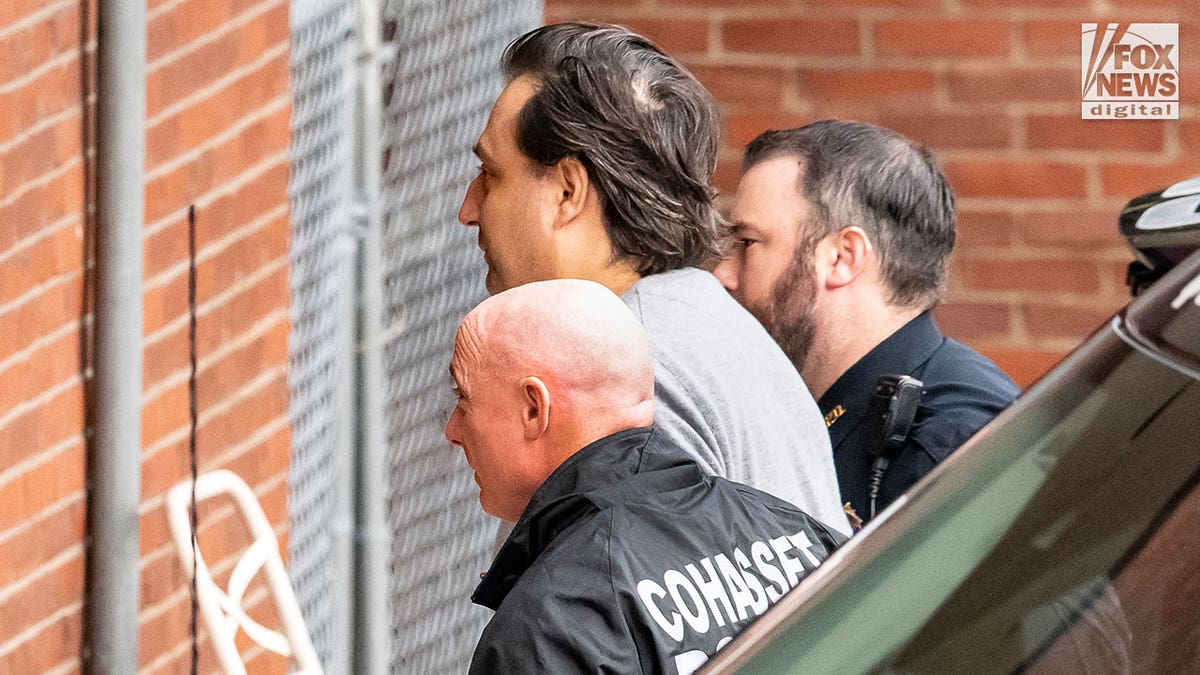 Man is led into court by two police officers