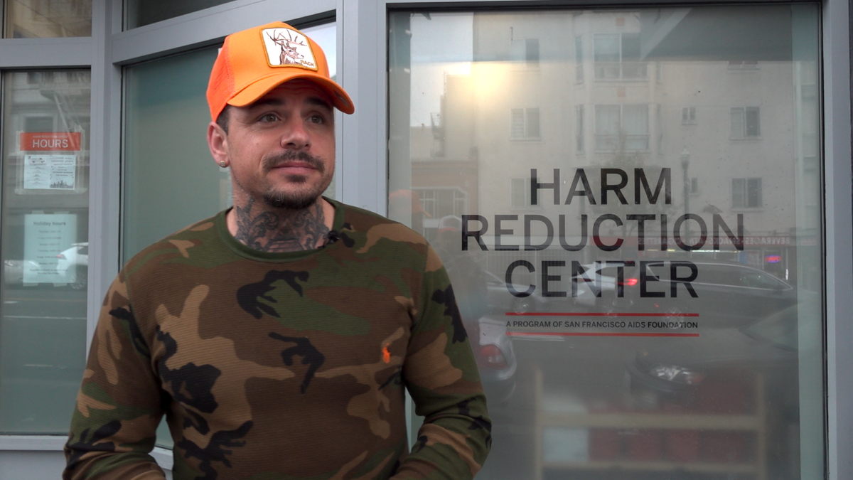 Ricci standing in front of a harm reduction center