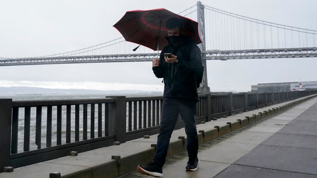 A man walks in the rain in San Francisco