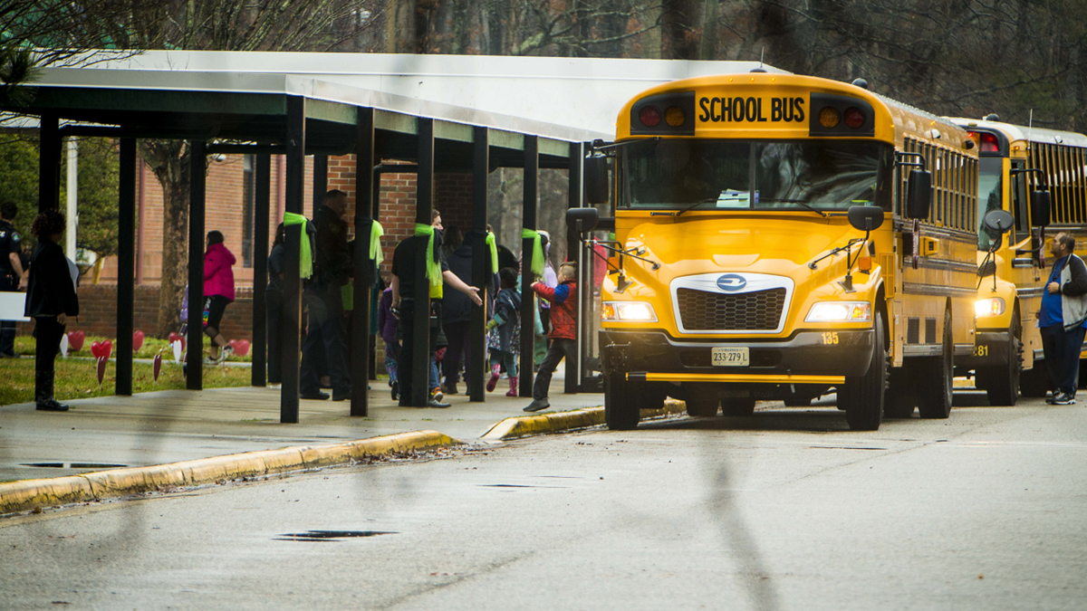 Buses arrive at Richneck Elementary School in Newport News, Virginia