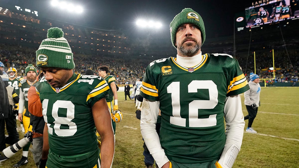 Aaron Rodgers and Randall Cobb walk off the football field