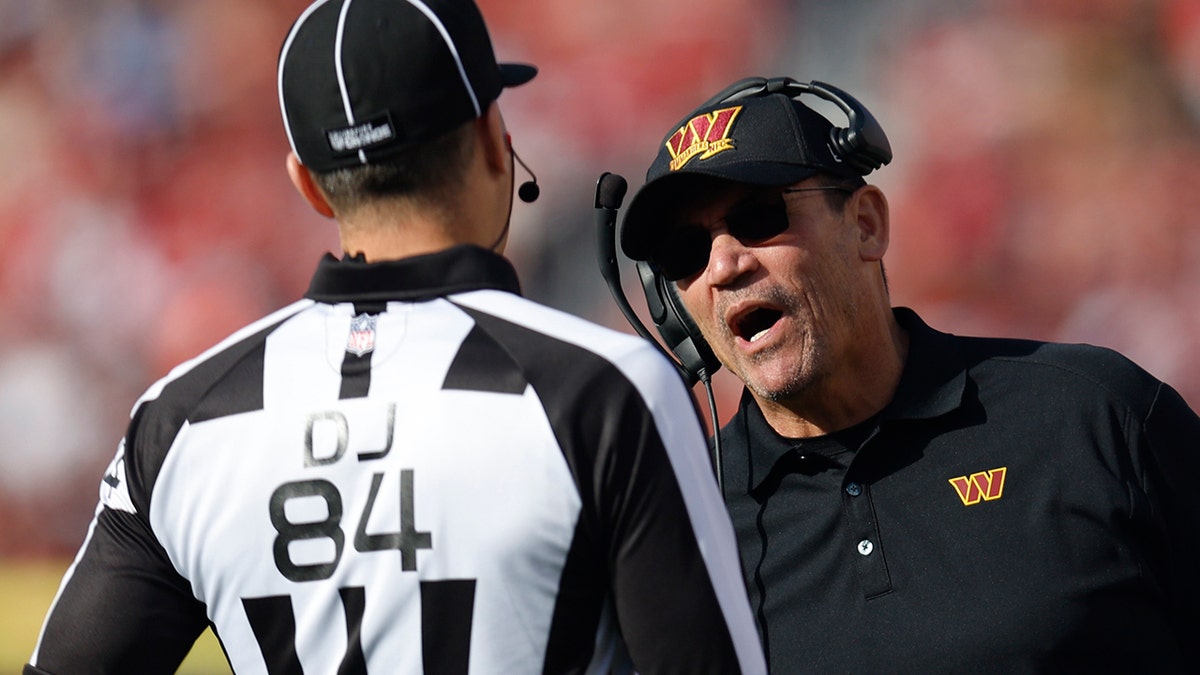 Ron Rivera talks to an official