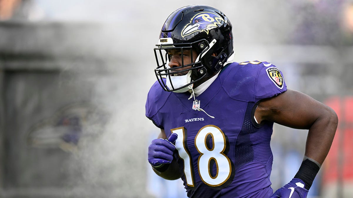 Baltimore Ravens player Roquan Smith runs on the football field during introductions