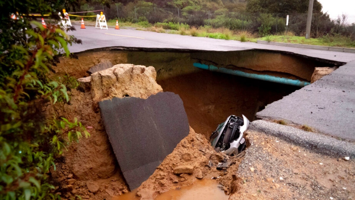 Cars in a large sinkhole