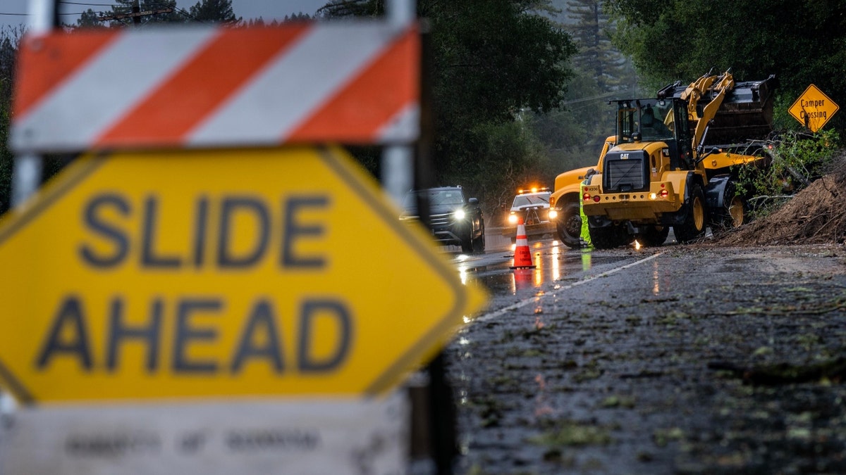 A road crew cleans a mudslide in California