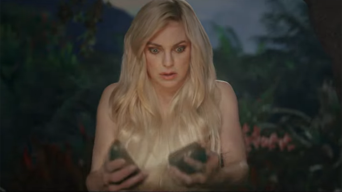 Anna Faris stares down at two halves of an illuminated Avocado in an advertisement