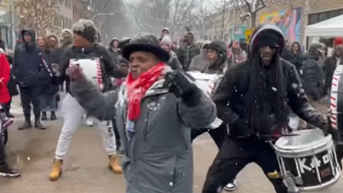 Lori Lightfoot dancing in winter coat outside