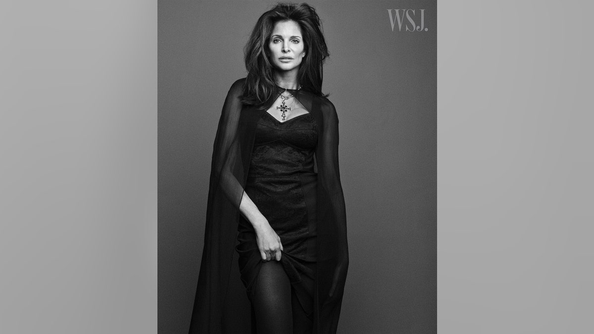 Stephanie Seymour modeling a black gown in a black and white photo