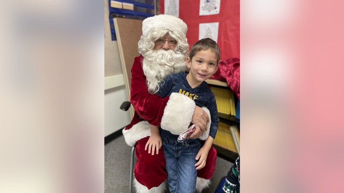 The boy sitting on Santa Claus