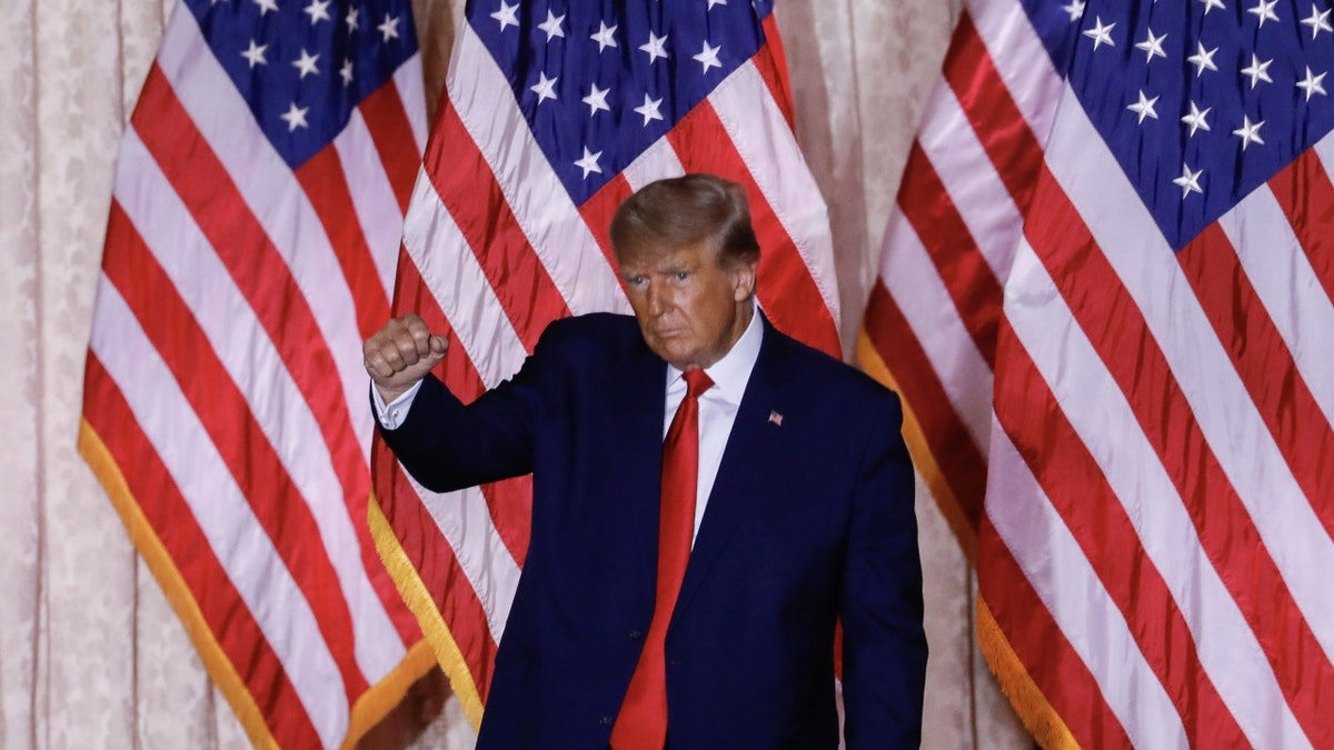 Former President Donald Trump in front of several American flags
