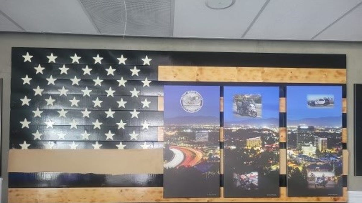 Image of the Thin Blue Line flag being masked at the LAPS Valley Traffic Division lobby. 