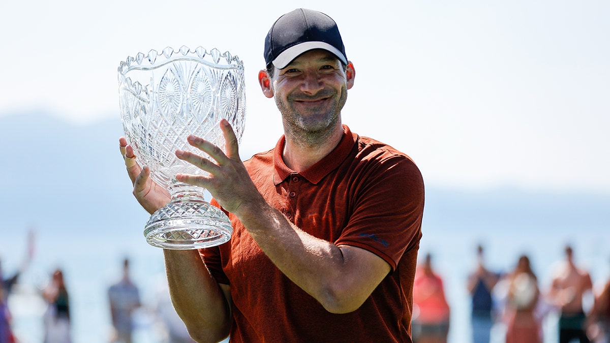 Tony Romo holds the trophy