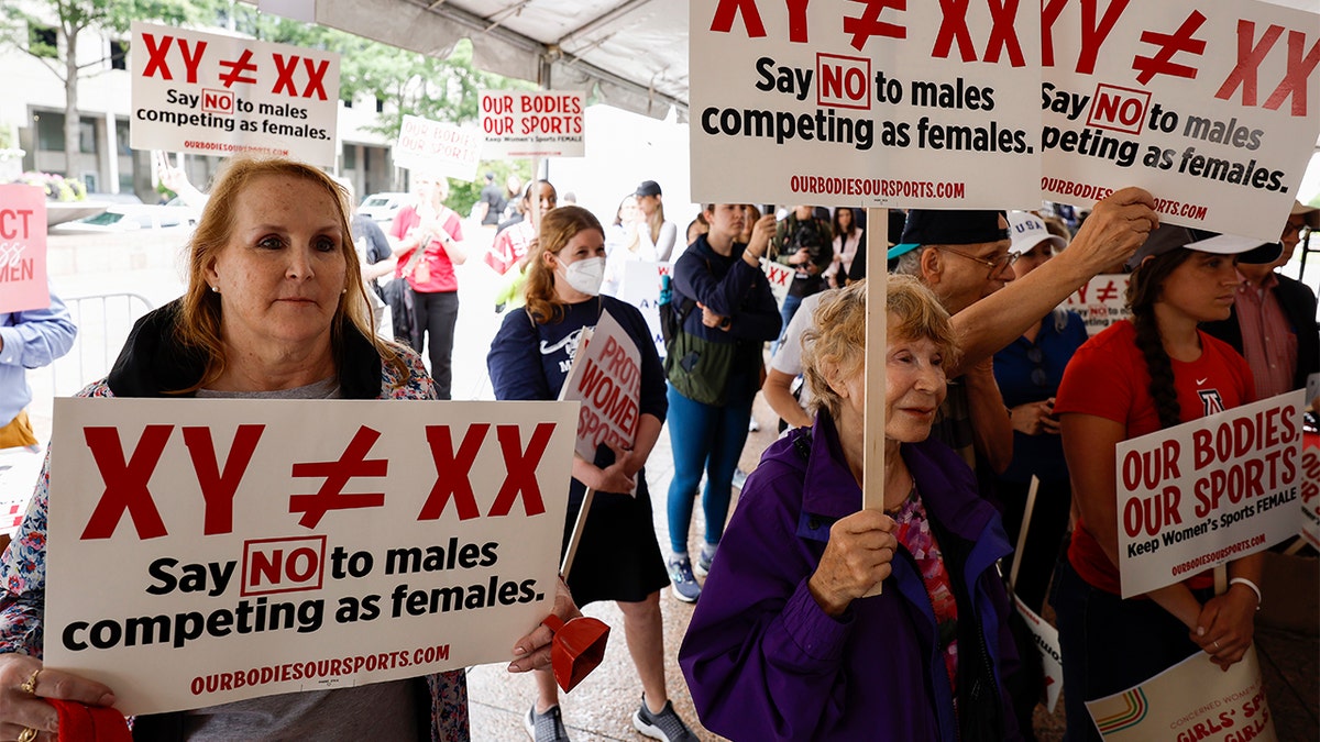 Demonstrators listen to the speaking program during an "Our Bodies, Our Sports" rally opposing biological males from competing with females in sports at Freedom Plaza in Washington, D.C., on June 23, 2022.