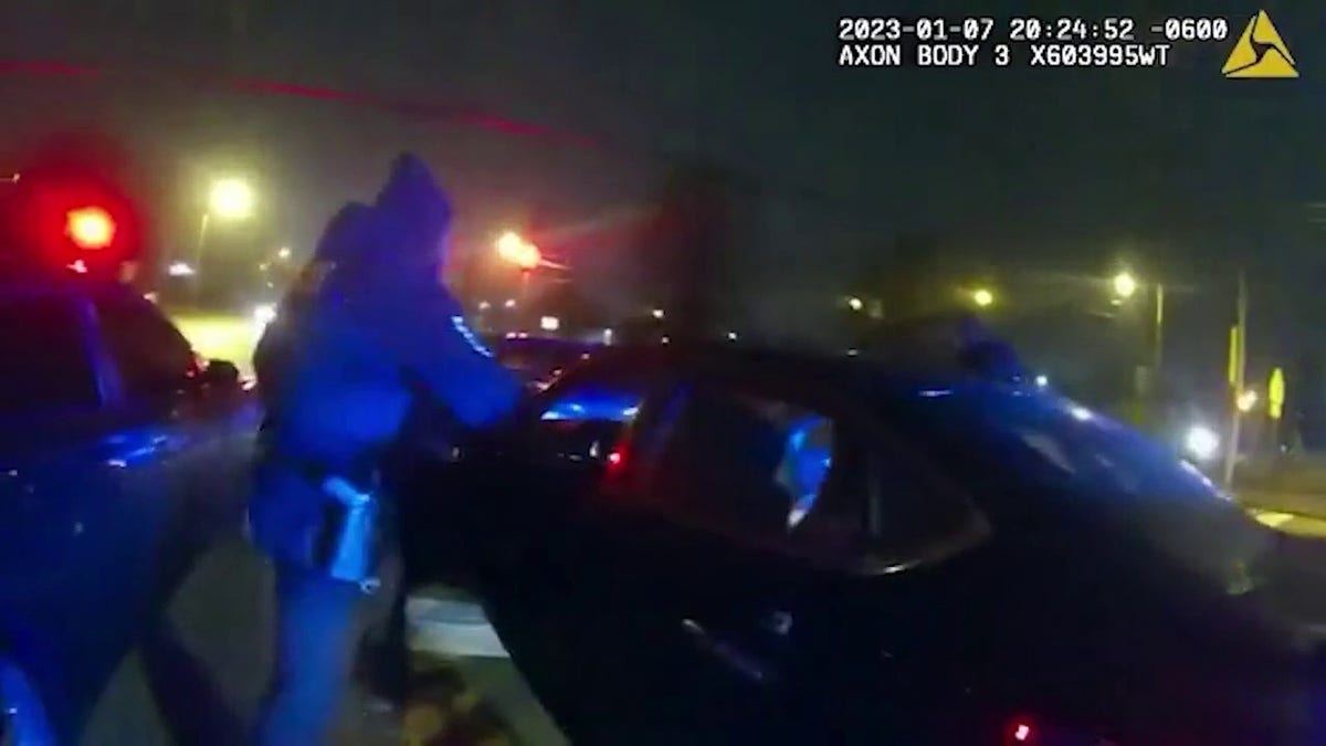 An officer approaching a car