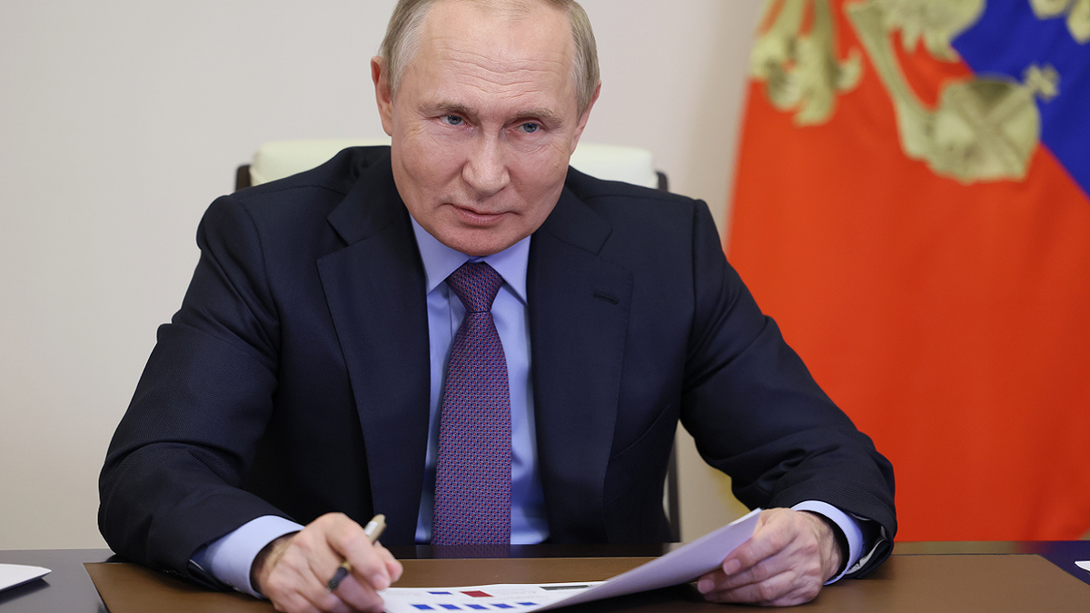 Putin with paper