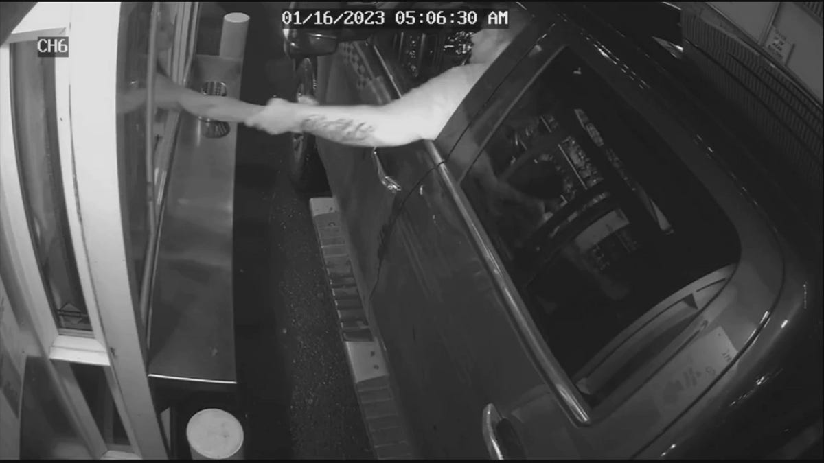 suspect grabbing barista through drive-thru