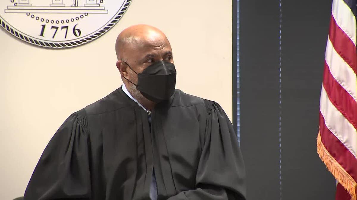 Judge wears face mask and robe in court