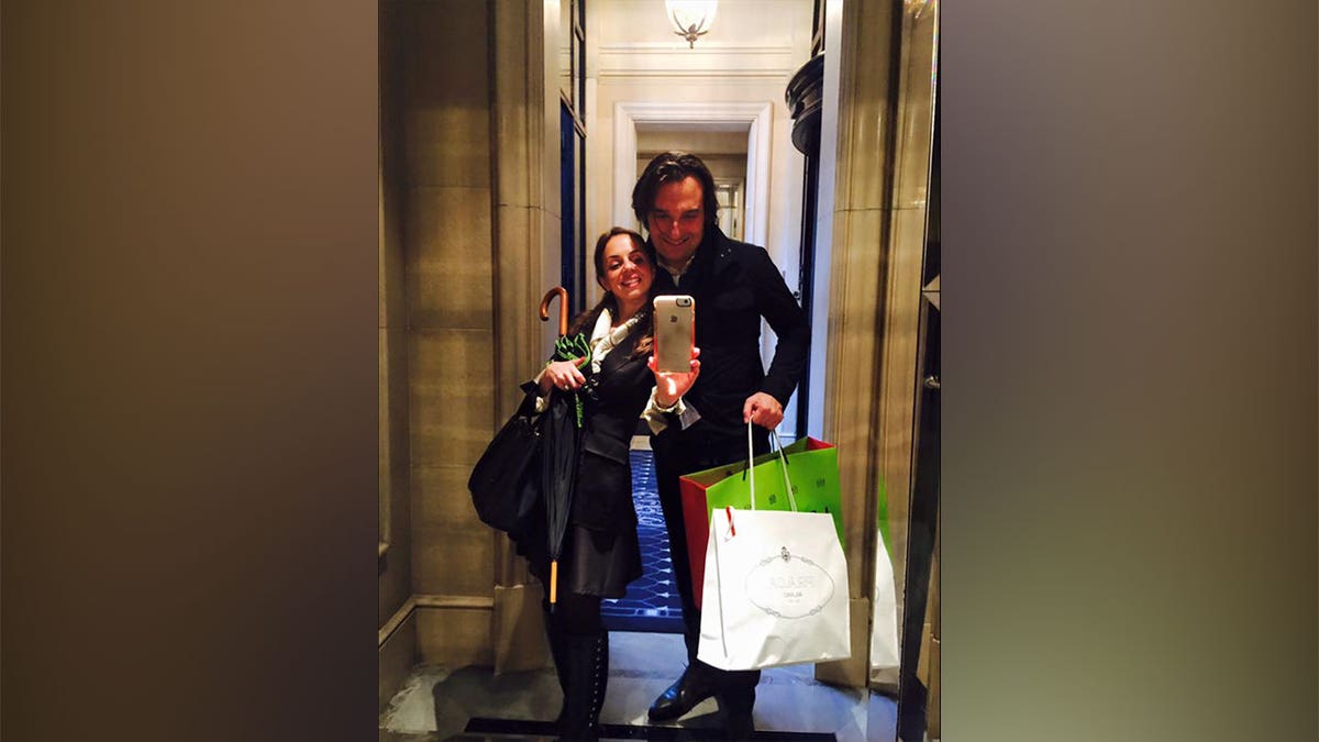 Ana Walshe and Brian Walshe hold shopping bags in a selfie