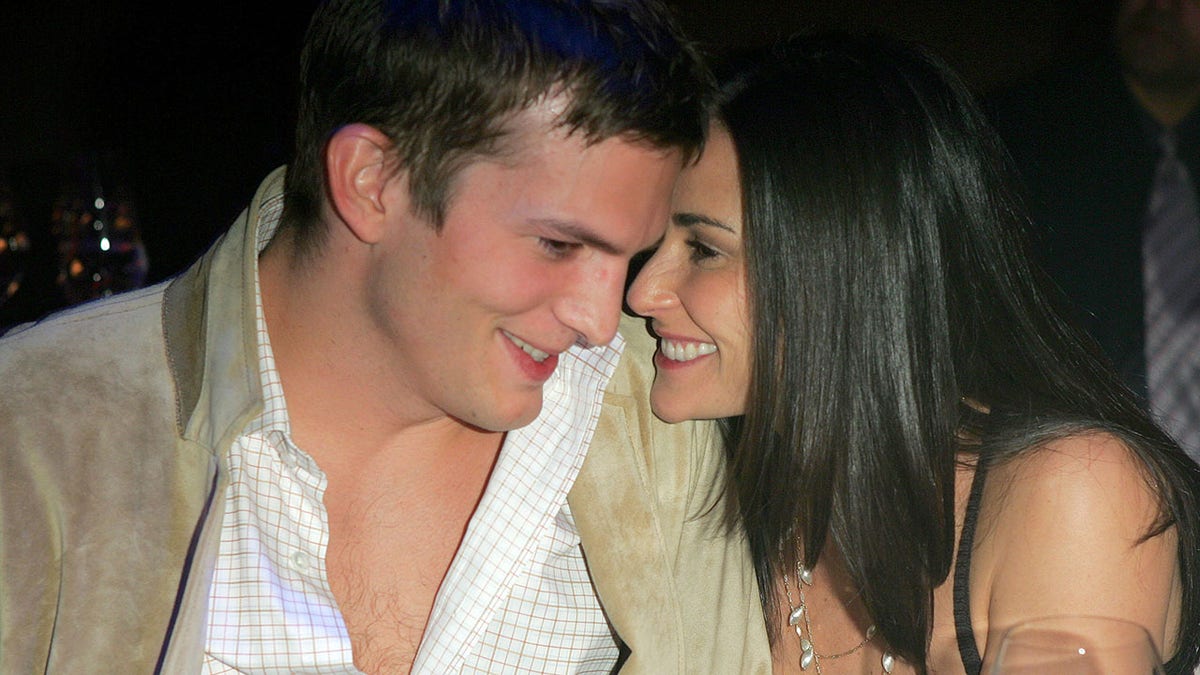 Demi Moore and Ashton Kutcher cozying up to each other