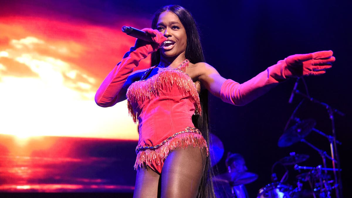Singer Azealia Banks on stage in pink outfit