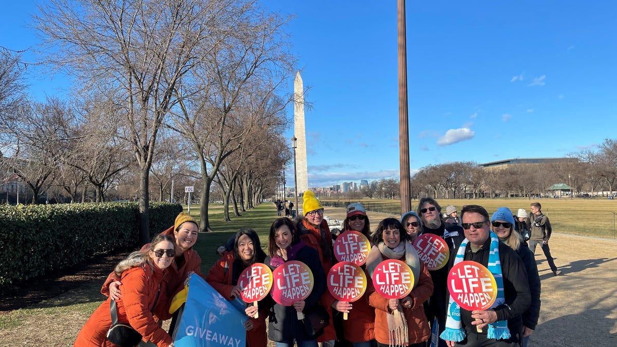 Actress Ashely Bratcher poses with members of Save the Storks at the 50th annual March for Life in Washington, D.C.