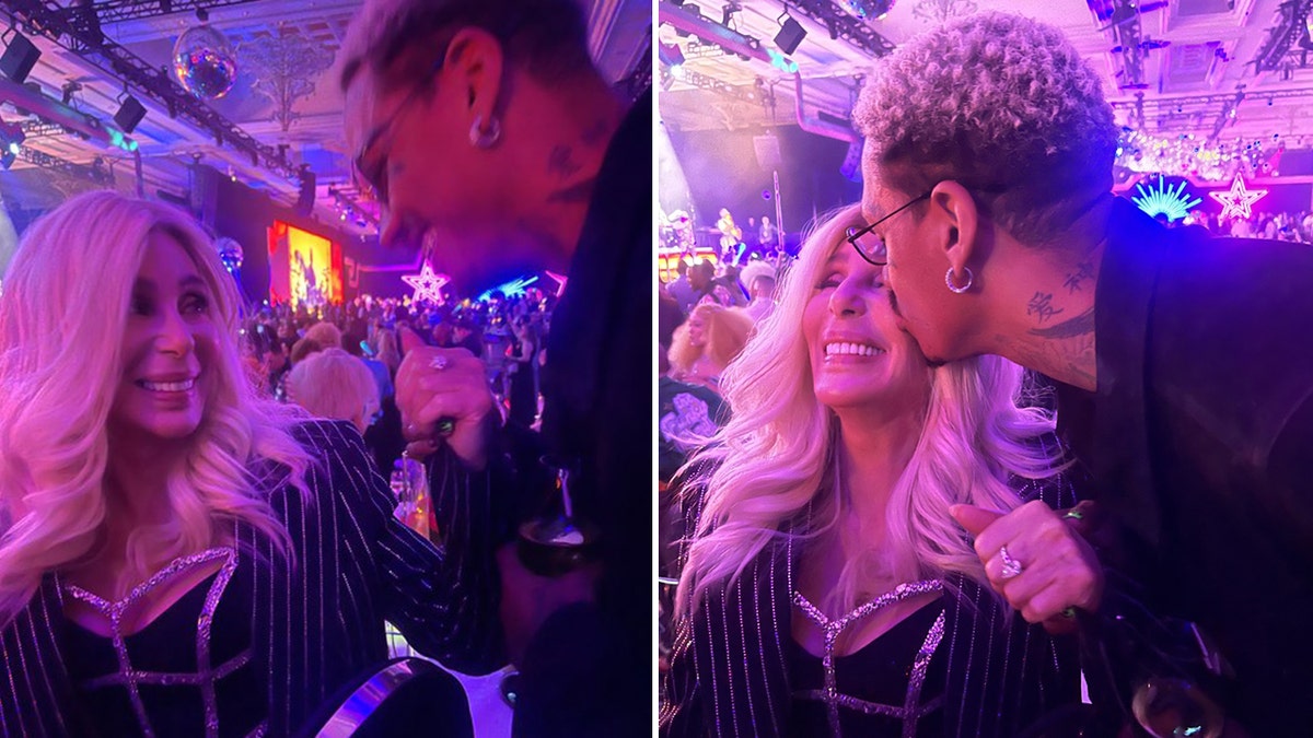 Cher glows as her boyfriend Alexander looks at her split Cher is kissed by her boyfriend Alexander