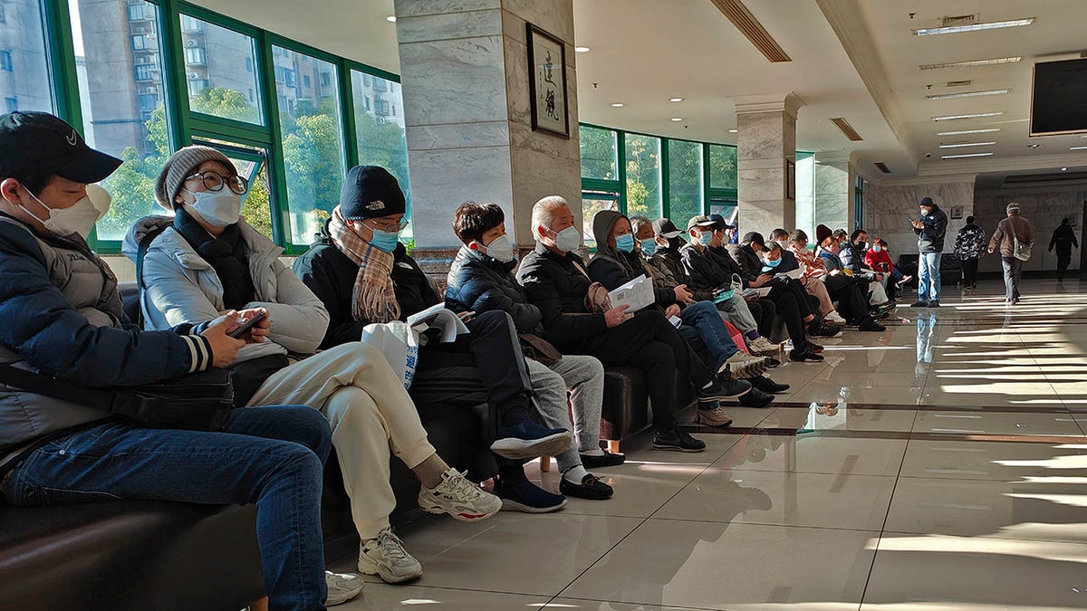 People wearing face masks at a funeral home in Shanghai