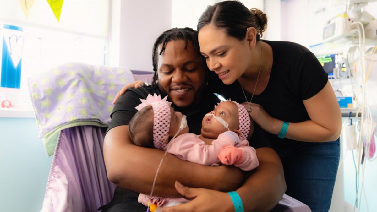 Amanda Arciniega and James Finley with their conjoined twin daughters