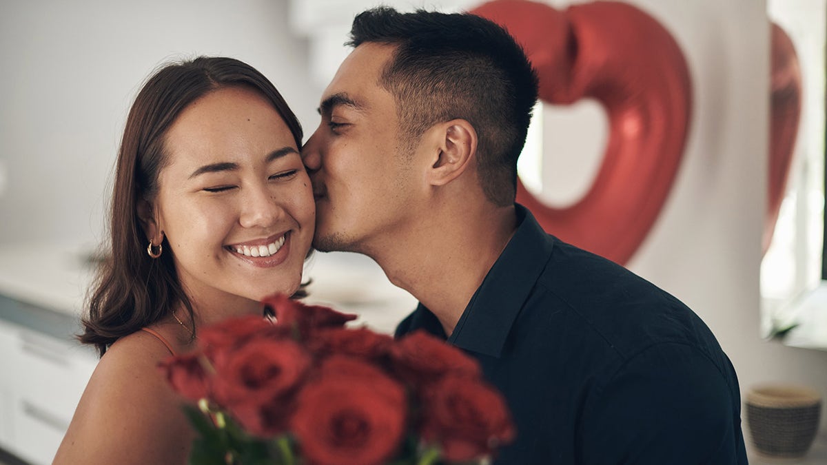 valentine's couple kiss on cheek