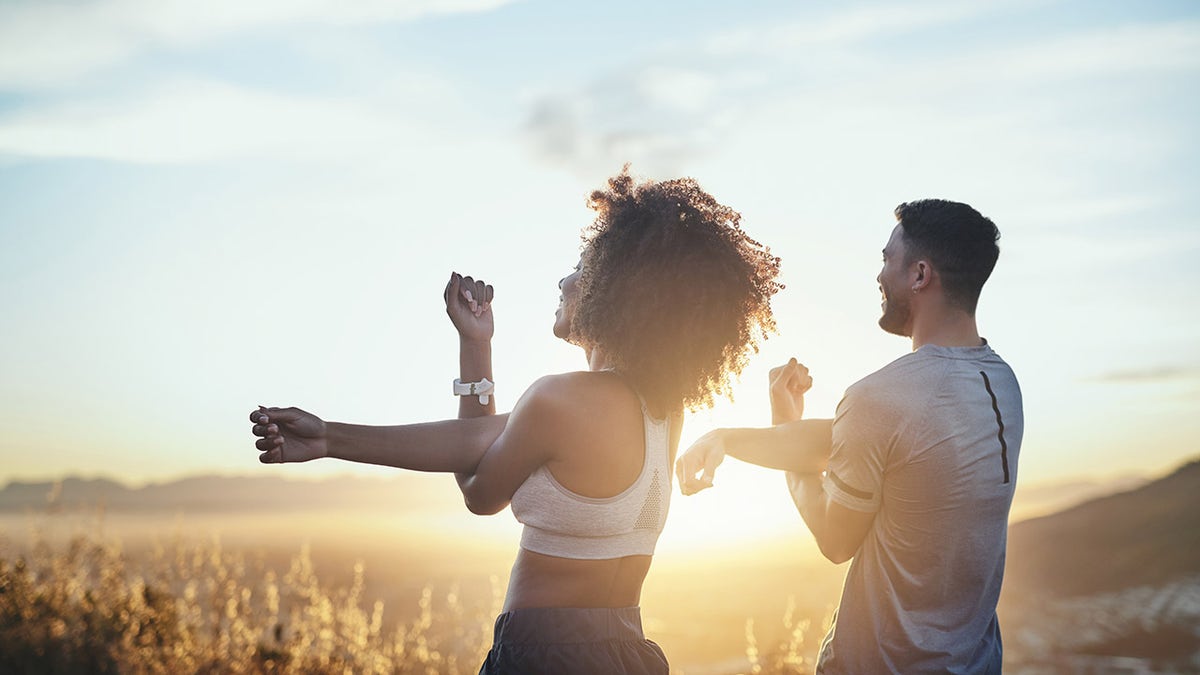 couple stretching health and fitness