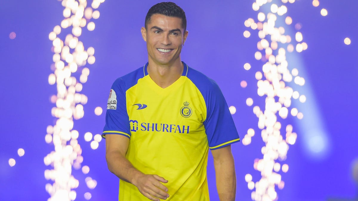 Cristiano Ronaldo smiles in stadium entrance