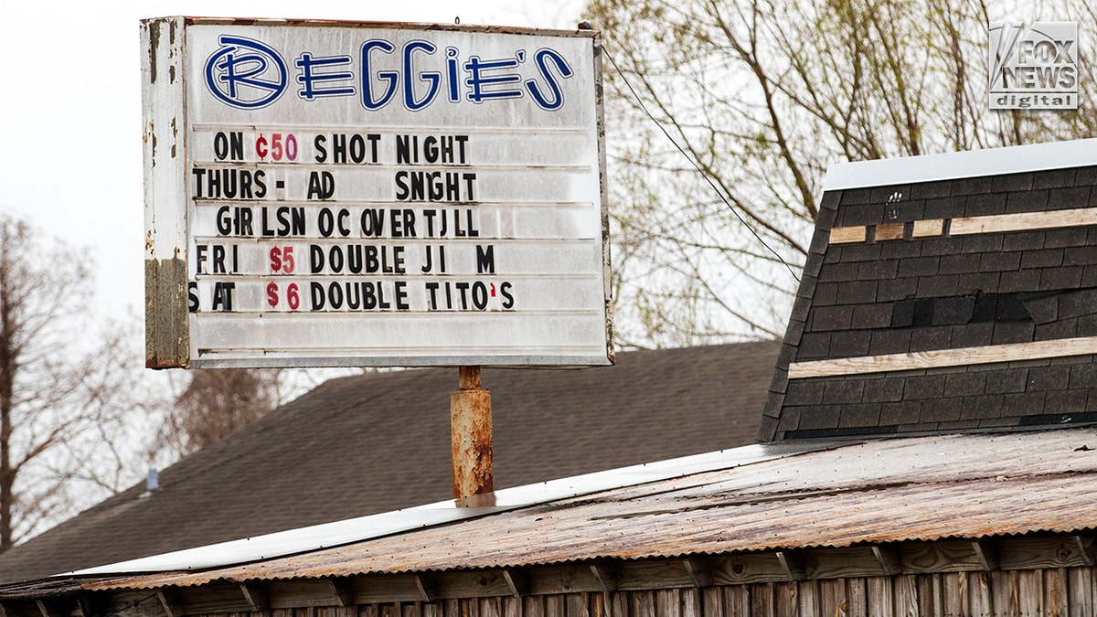 A close-up shot of a restaurant sign on a roof.