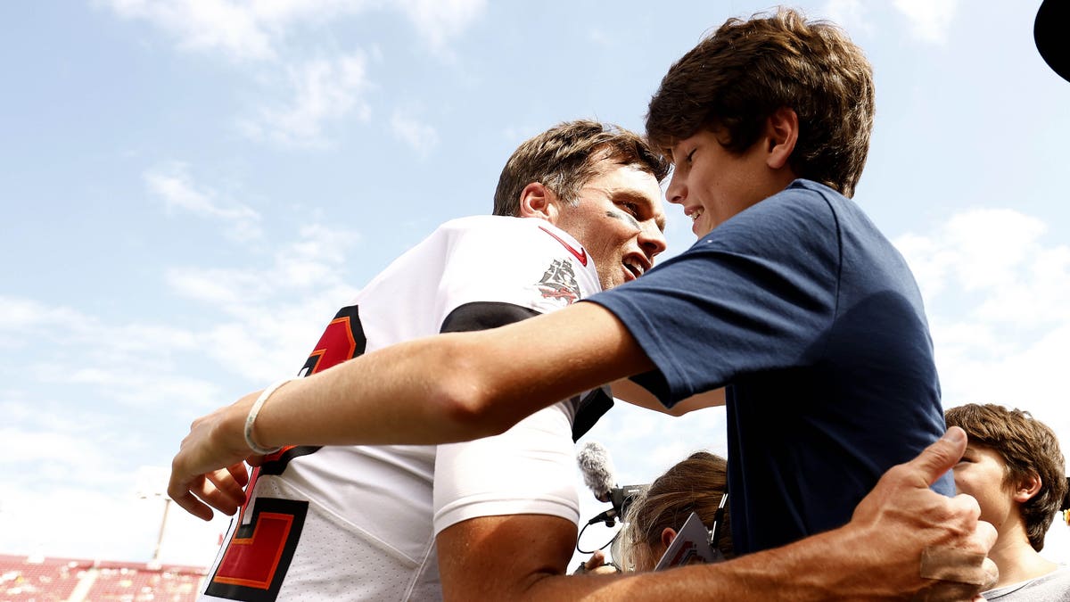 Tom Brady hugs son