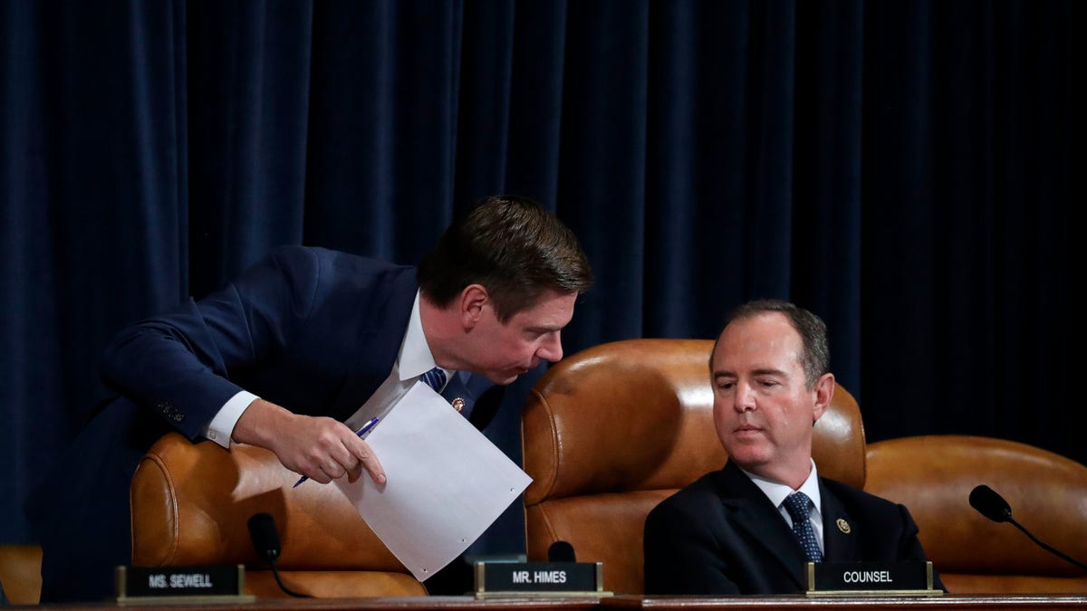Rep. Eric Swalwell (D-CA) confers with committee chairman Rep. Adam Schiff (D-CA)