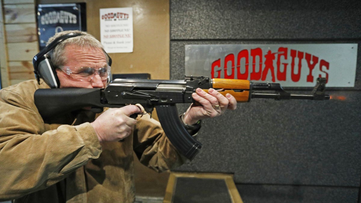 Vince Warner fires an AK-47 with a bump stock installed at Good Guys Gun and Range