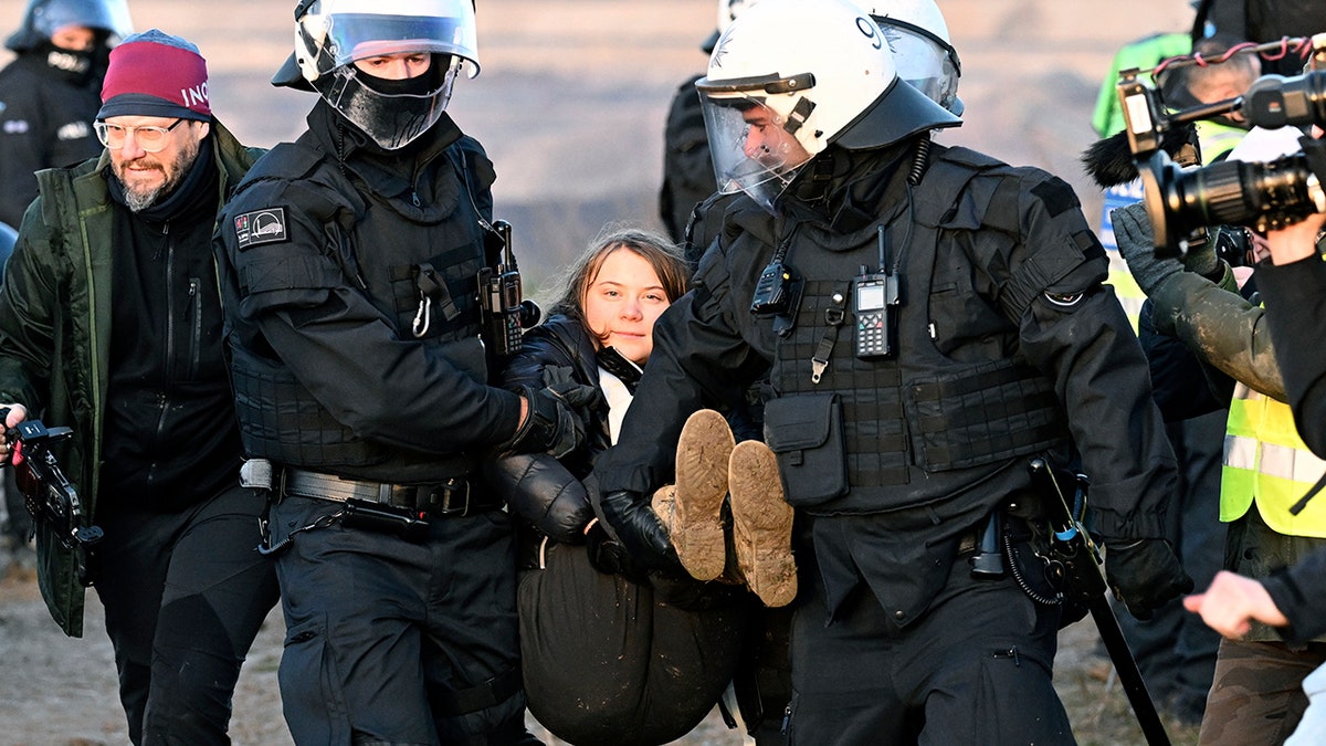 police carrying Greta Thunberg