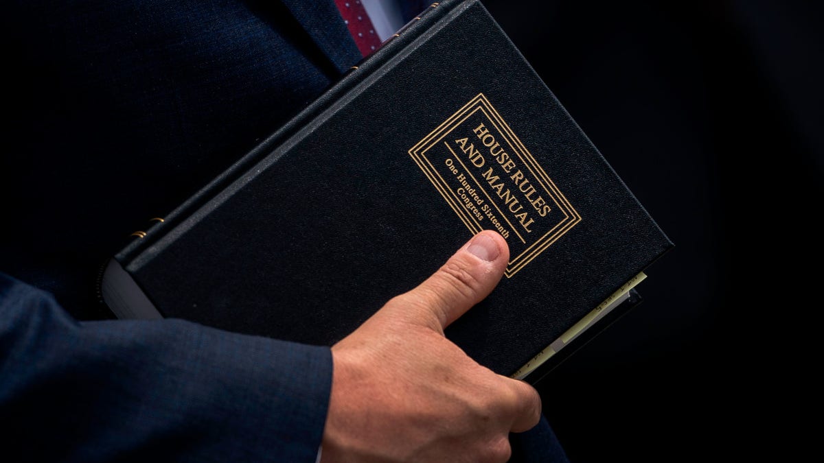 Rep. Mike Johnson (R-LA) holds a House Rules and Manual book during a news conference outside the U.S. Capitol, May 27, 2020 in Washington, DC.