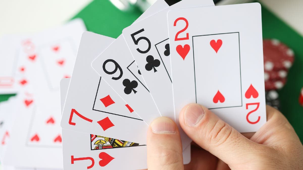 Closeup view of a person holding playing cards