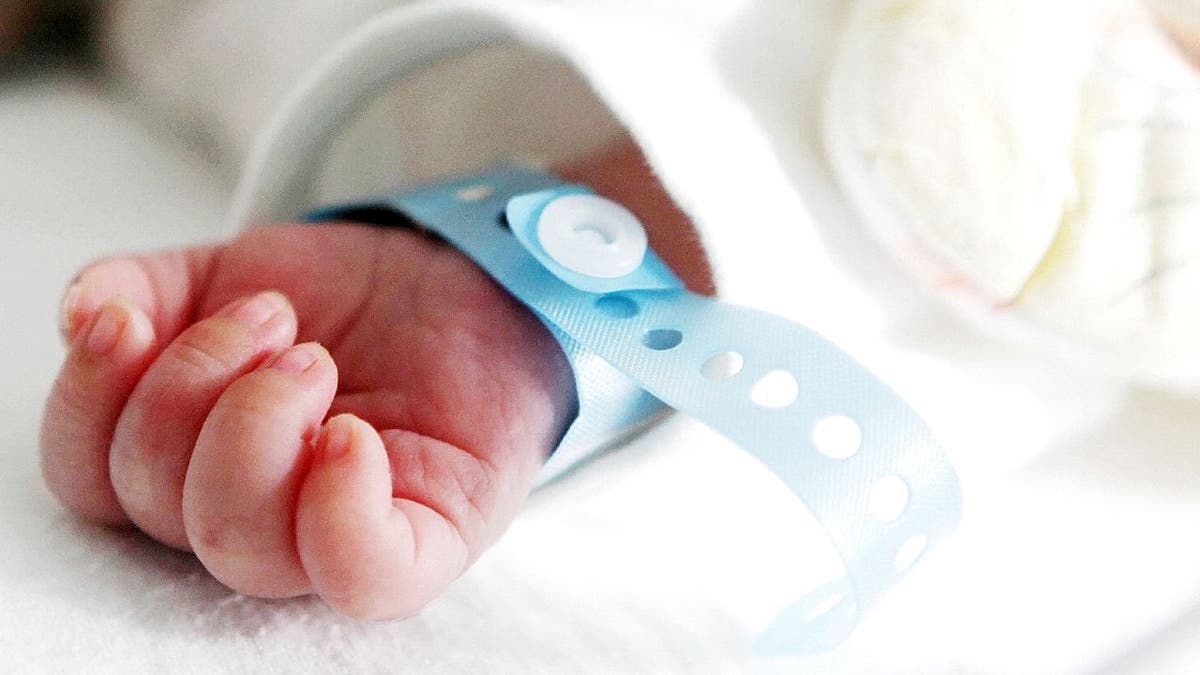 Baby boy with blue hospital bracelet