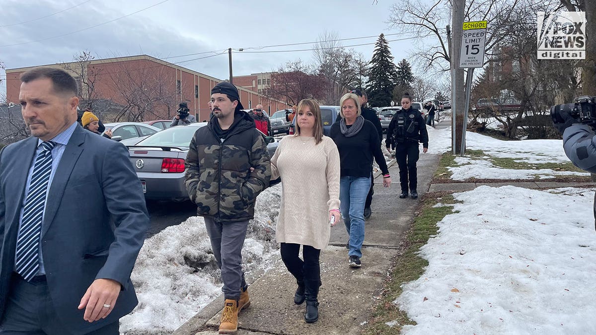 Family walks on sidewalk