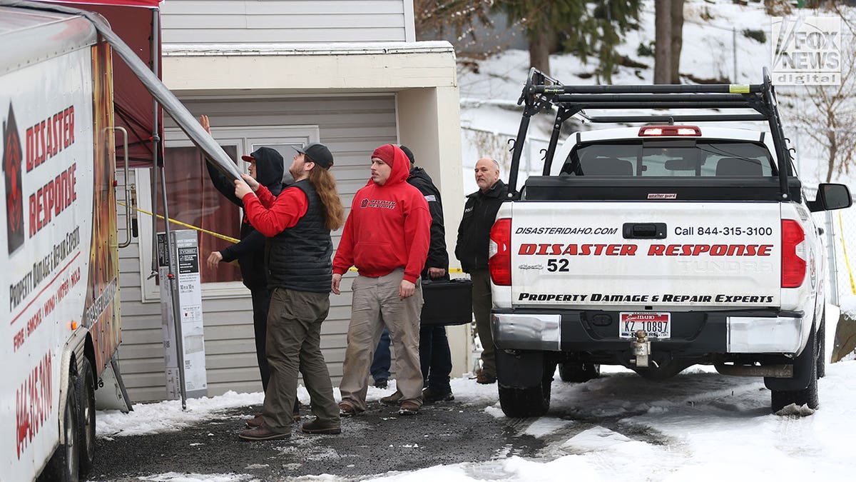 Investigators walk through King Road murder scene