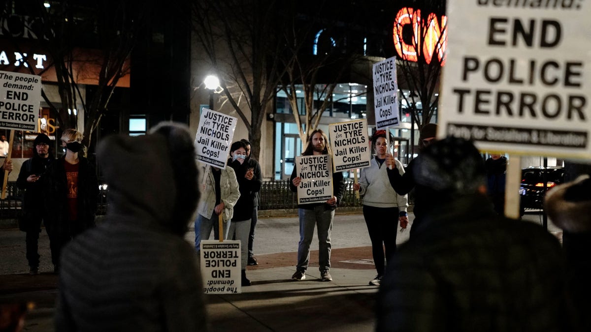 Protesters hold signs during a rally against the fatal police assault of Tyre Nichols, in Atlanta, on January 27, 2023. - The US city of Memphis released January 27, 2023 graphic video footage depicting the fatal police assault of a 29-year-old Black man, as cities nationwide braced for a night of protests against police brutality. Five Memphis officers, also all Black, were charged with second-degree murder in the beating of Tyre Nichols, who died in hospital on January 10 three days after being stopped on suspicion of reckless driving. (Photo by CHENEY ORR / AFP) (Photo by CHENEY ORR/AFP via Getty Images) 