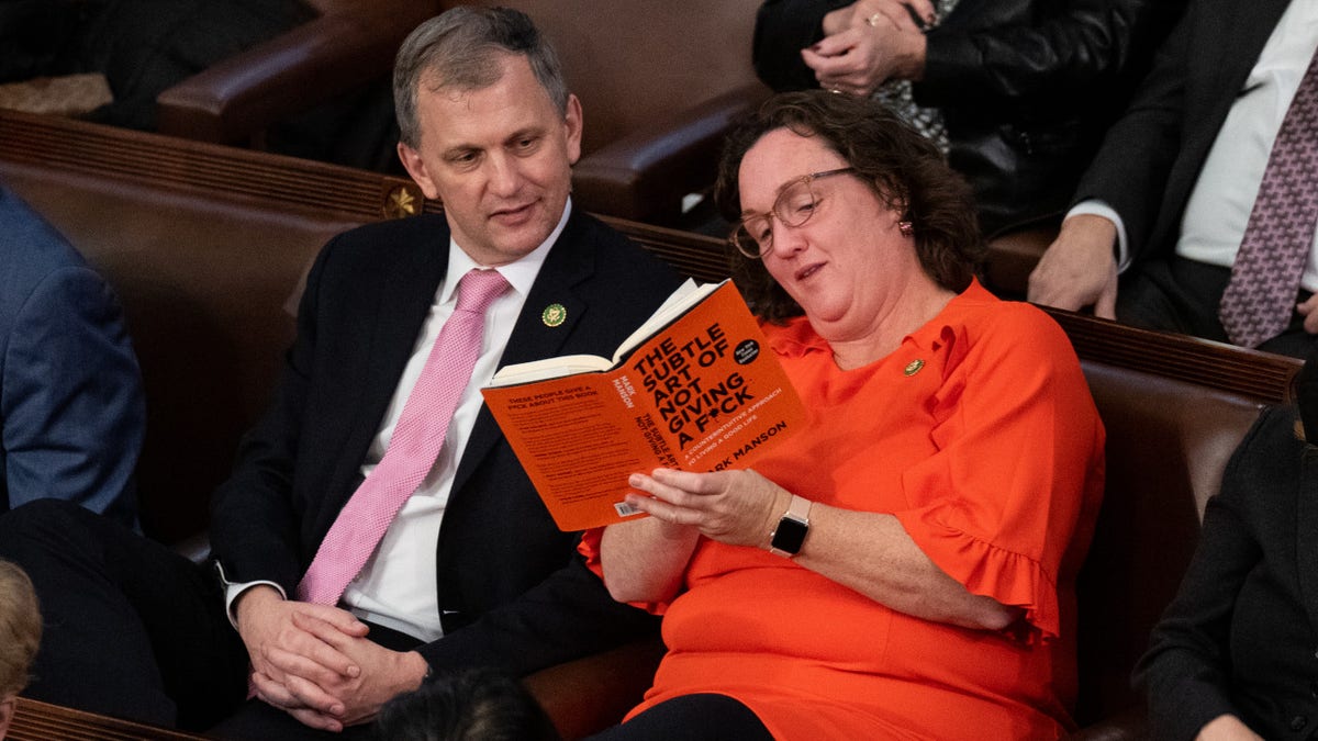 Rep. Katie Porter, D-Calif., shows her book to Rep. Sean Casten, D-Ill.