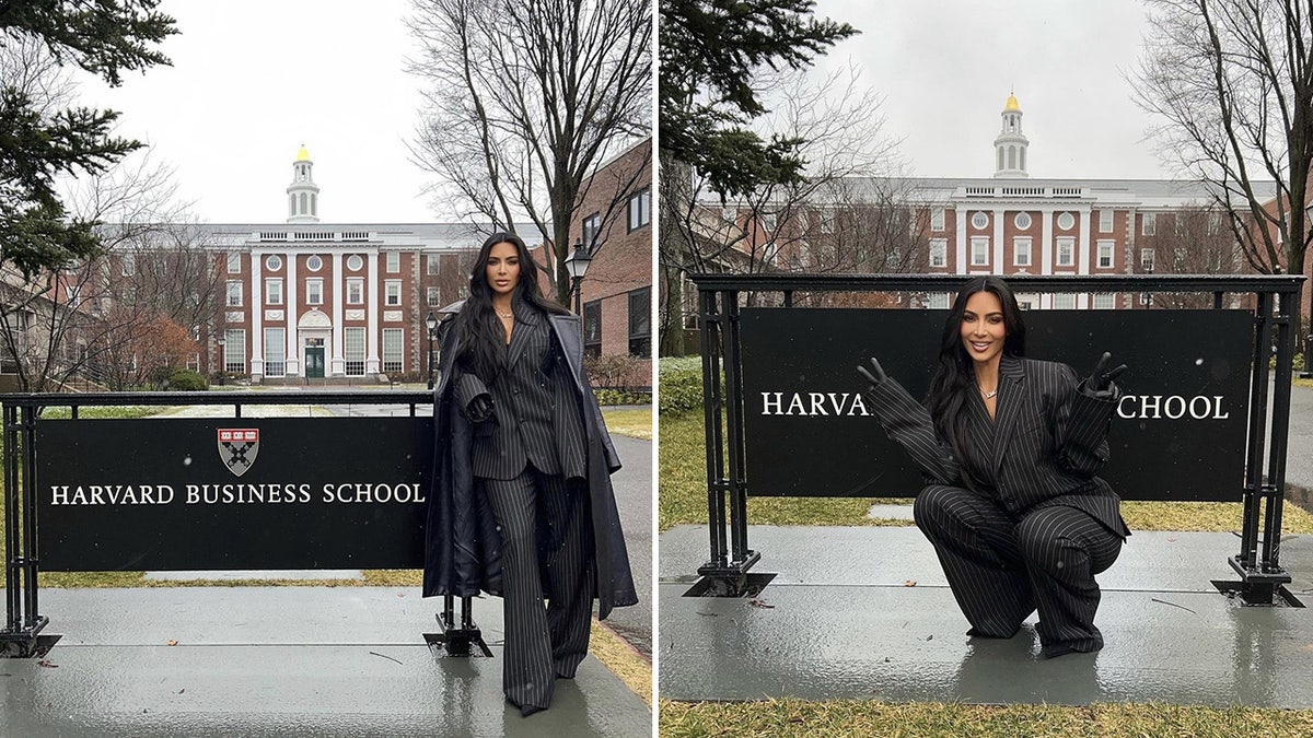 Kim Kardashian in a pinstripe black and white suit poses next to a sign that reads "Harvard Business School" split she crouches and does two peace signs in front of the sign
