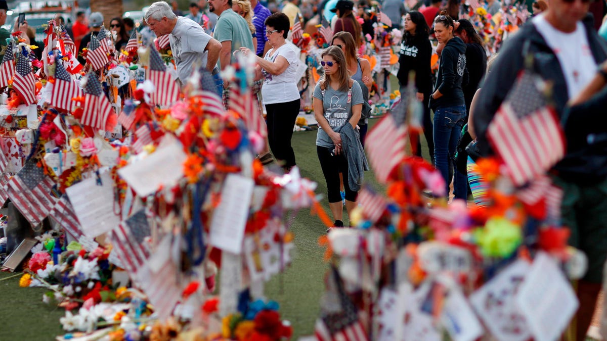 People visit a makeshift memorial honoring the victims of the Oct. 1 mass shooting on Nov. 12, 2017, in Las Vegas.