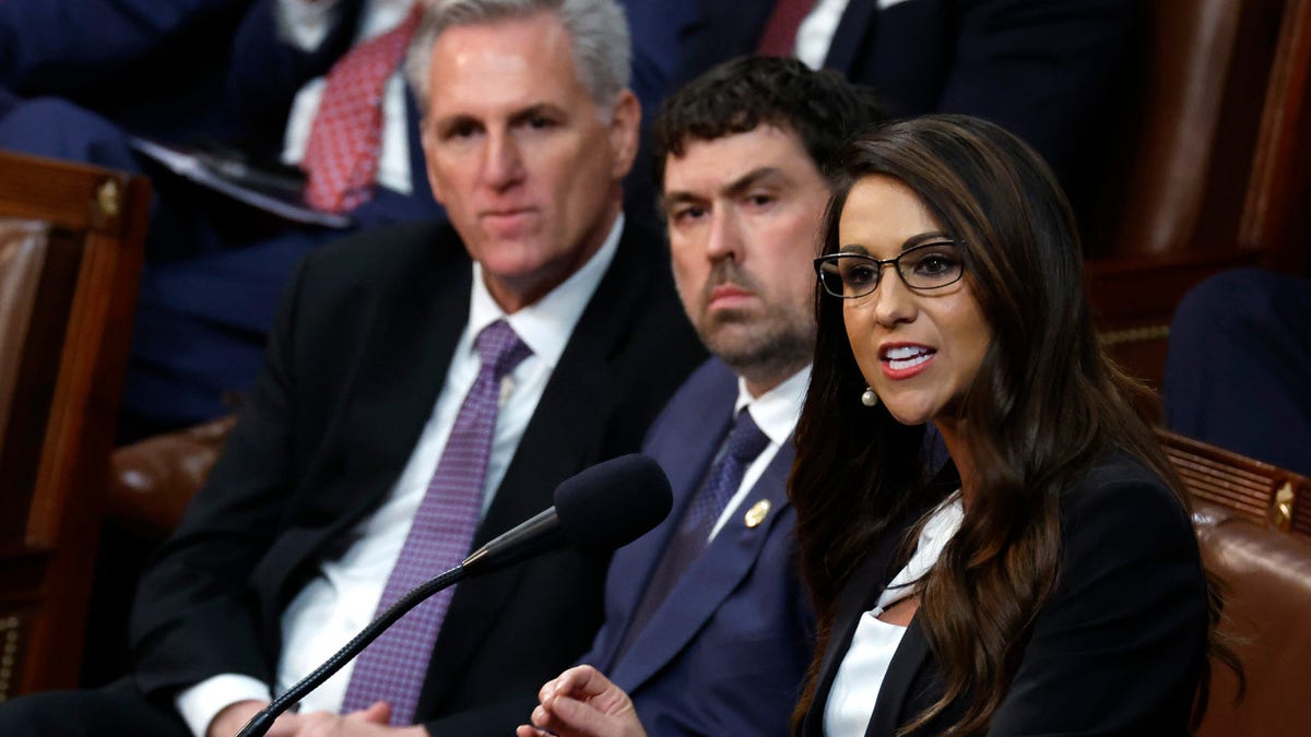 U.S. Rep.-elect Lauren Boebert (R-CO) (R) delivers remarks alongside House Republican Leader Kevin McCarthy (L) in the House Chamber