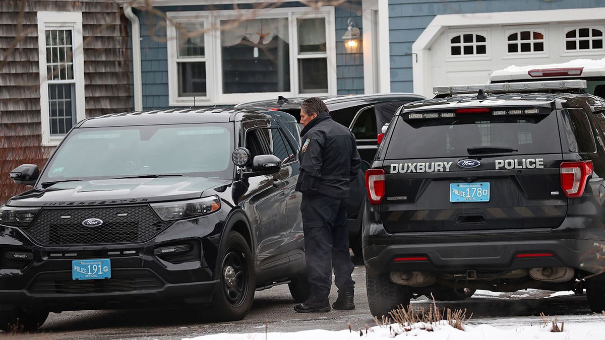 MA police parked out front with vehicles of a Massachusetts house