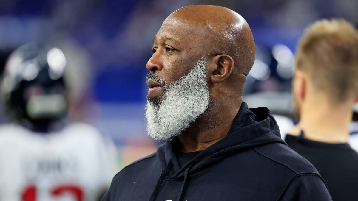 Lovie Smith looks on field