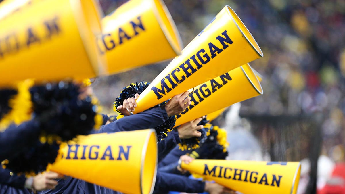 Michigan megaphones on the sidelines during a football game