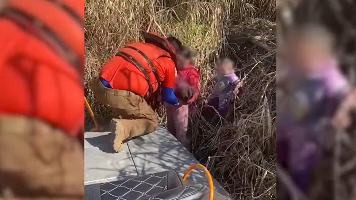 Still image from a video released by the Mexican National Institute of Migration showing the rescue of three sisters abandoned at the border.